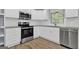 Modern kitchen featuring stainless steel appliances, white cabinets, and granite countertops at 2315 Shancey Ln, South Fulton, GA 30349