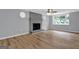 Cozy living room with a brick fireplace, bay window, and hardwood floors at 2315 Shancey Ln, South Fulton, GA 30349