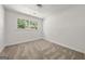 Cozy bedroom featuring neutral carpet and a large window with a wooded view at 37 S Forty Pass W, Hiram, GA 30141
