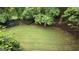 Spacious, green backyard surrounded by lush trees, perfect for outdoor activities at 2329 Lochinver Sw Ln, Conyers, GA 30094