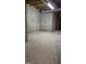 Unfinished basement space with concrete walls and floor, showing exposed pipes and wooden beams at 2329 Lochinver Sw Ln, Conyers, GA 30094