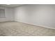 Finished basement with drop ceiling, neutral tile flooring, and a window at 2329 Lochinver Sw Ln, Conyers, GA 30094