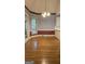Dining room features hardwood floors, a window with blinds, and a chandelier light fixture at 2329 Lochinver Sw Ln, Conyers, GA 30094