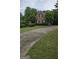Charming brick home with a well-manicured lawn and a curved driveway at 2329 Lochinver Sw Ln, Conyers, GA 30094