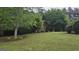 Brick home with manicured lawn and mature trees offering privacy at 2329 Lochinver Sw Ln, Conyers, GA 30094