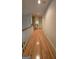 Upstairs hallway features hardwood flooring and white trim at 2329 Lochinver Sw Ln, Conyers, GA 30094