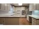 Kitchen with white cabinets, stainless appliances, hardwood floors, and wood countertops at 2329 Lochinver Sw Ln, Conyers, GA 30094