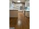 Bright kitchen featuring white cabinets, stainless steel appliances, and hardwood floors at 2329 Lochinver Sw Ln, Conyers, GA 30094