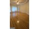 Hardwood floored living room featuring white trim, natural light from the windows and a ceiling fan at 2329 Lochinver Sw Ln, Conyers, GA 30094