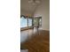 Living room featuring hardwood floors and windows with drapes and access to a staircase at 2329 Lochinver Sw Ln, Conyers, GA 30094
