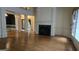 Expansive living room featuring a fireplace, hardwood floors, and elegant columns at 2329 Lochinver Sw Ln, Conyers, GA 30094