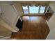View of a hardwood floored living room with fireplace, large windows, and ceiling fan at 2329 Lochinver Sw Ln, Conyers, GA 30094