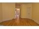 Hardwood floored living room featuring white trim and tan walls with access to other living spaces at 2329 Lochinver Sw Ln, Conyers, GA 30094