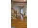 View of a hardwood floored living room that features a carpeted staircase and access to the living space at 2329 Lochinver Sw Ln, Conyers, GA 30094