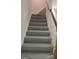 Carpeted staircase with white banister at 2329 Lochinver Sw Ln, Conyers, GA 30094