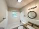 Bright bathroom with white tile, a vanity with granite countertops and a shower-tub combo at 250 Glenrose Sw Cir, Atlanta, GA 30354