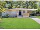 Charming single-story home with a well-manicured lawn, carport, and inviting front porch at 250 Glenrose Sw Cir, Atlanta, GA 30354