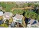 Aerial view of a two-story home with well-manicured lawn, landscaping and two-car garage near a pond at 3213 Blackley Old Rd, Douglasville, GA 30135