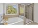 Bright bathroom featuring a soaking tub and a glass-enclosed shower at 3213 Blackley Old Rd, Douglasville, GA 30135
