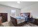 Cozy bedroom featuring a wooden bed frame, plush bedding, and carpet flooring at 3213 Blackley Old Rd, Douglasville, GA 30135