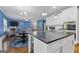 Open-concept kitchen and living room with a large island and modern appliances at 3213 Blackley Old Rd, Douglasville, GA 30135
