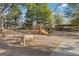 Community playground with various play structures and equipment for children, surrounded by trees and grass at 3213 Blackley Old Rd, Douglasville, GA 30135