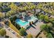 Aerial view of a community pool area with swimming pools, lounge chairs, and a covered pavilion for residents at 3213 Blackley Old Rd, Douglasville, GA 30135