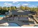 Aerial view of a community pool area with outdoor seating and a pavilion, perfect for summer fun at 3213 Blackley Old Rd, Douglasville, GA 30135