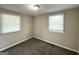 Inviting bedroom with plush carpet, natural light from the windows, and neutral paint at 3317 Renault Se Rd, Atlanta, GA 30354