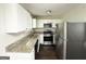Modern kitchen with stainless steel appliances, granite countertops, and white cabinetry at 3317 Renault Se Rd, Atlanta, GA 30354