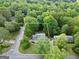 Aerial view of house showing the house surrounded by mature shade trees and professional landscaping at 3440 Concord Se Cor, Conyers, GA 30013