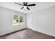 Bedroom features hardwood floors, new fan and light fixture, double pane windows, and freshly painted walls at 3440 Concord Se Cor, Conyers, GA 30013