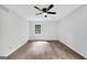 An empty bedroom with a ceiling fan, hardwood floors, and a window at 3440 Concord Se Cor, Conyers, GA 30013
