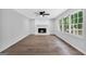 Cozy living room featuring hardwood floors and a brick fireplace at 3440 Concord Se Cor, Conyers, GA 30013