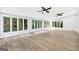 Large living room with walls of windows, freshly painted walls, new hardwood floors, and updated fan fixtures at 3440 Concord Se Cor, Conyers, GA 30013