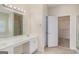 Ensuite bathroom features dual vanity, large mirror, and a separate shower and bath, and walk-in closet at 3634 Cape Ln, Conyers, GA 30013