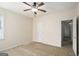 Neutral carpeted bedroom featuring a ceiling fan, walk-in closet, and one window at 3634 Cape Ln, Conyers, GA 30013