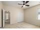 Neutral carpeted bedroom featuring a ceiling fan, closet, and one window at 3634 Cape Ln, Conyers, GA 30013