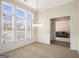 Formal dining room with large windows, chandelier, neutral walls, and plush carpet flooring at 3634 Cape Ln, Conyers, GA 30013