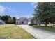Lovely single-Gathering home with a well-manicured front lawn and long driveway leading to a two-car garage at 3634 Cape Ln, Conyers, GA 30013