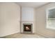 Corner fireplace with a decorative mantel and tile surround creates a cozy focal point in the room at 3634 Cape Ln, Conyers, GA 30013