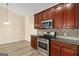 Kitchen featuring granite countertops, stainless steel appliances, and dark wood cabinetry at 3634 Cape Ln, Conyers, GA 30013