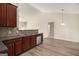 Kitchen featuring stainless steel dishwasher, granite countertops, and updated flooring at 3634 Cape Ln, Conyers, GA 30013