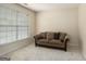 Cozy living room with plush carpet, soft lighting, a large window, and comfortable sofa at 3634 Cape Ln, Conyers, GA 30013
