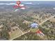 Aerial view showing property location near the Tussahaw Reservoir and a home on a wooded lot at 3911 Peeksville Rd, Locust Grove, GA 30248