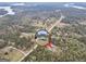 Aerial shot showcases property with house in a circle on a wooded lot, conveniently located by main road at 3911 Peeksville Rd, Locust Grove, GA 30248