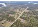 Aerial view of the property, showing its location near a lake and surrounded by dense trees at 3911 Peeksville Rd, Locust Grove, GA 30248