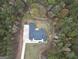 Birds eye view of roof on house surrounded by trees on a wooded lot with a stone driveway at 3911 Peeksville Rd, Locust Grove, GA 30248
