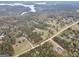 Aerial view of the home on a wooded lot, with views of a nearby lake and surrounding trees at 3911 Peeksville Rd, Locust Grove, GA 30248