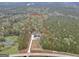 Aerial view of a home and property, surrounded by trees and a red line showing the property line at 3911 Peeksville Rd, Locust Grove, GA 30248